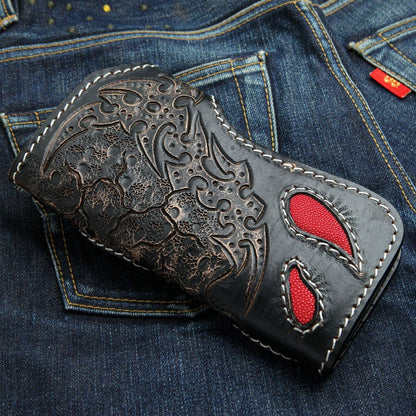 Two teardrop cutouts open onto red stingray beneath the embossed scrollwork, outlined in white stitching.