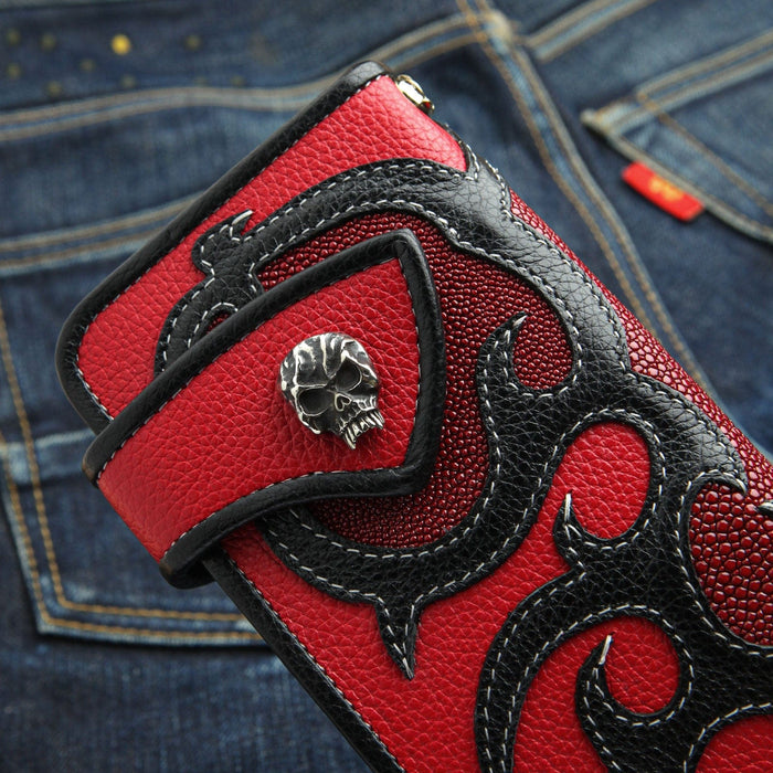 A close-up of the solid sterling silver skull concho on the red and black leather biker wallet.
