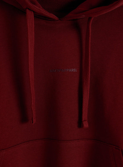 Ruby red chunky cotton terry hoodie featuring a drawstring and tonal aim'n logo.