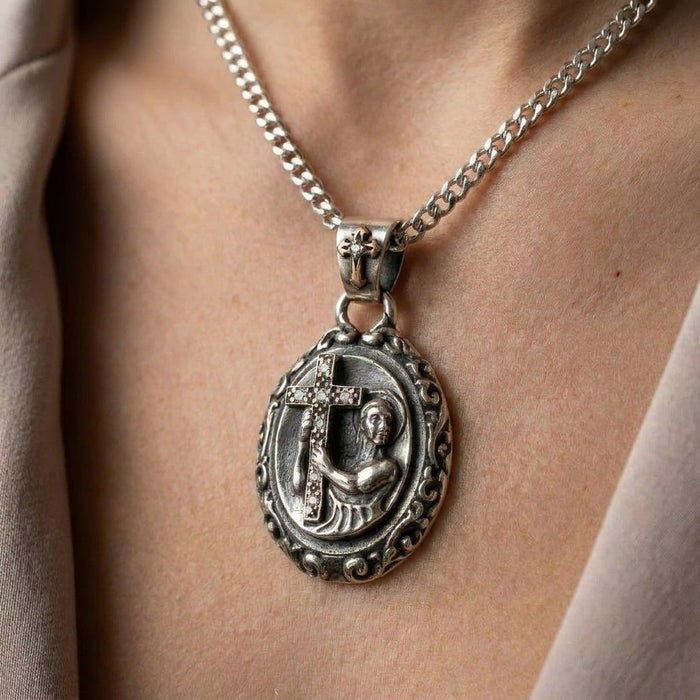 Model wearing the oxidized sterling silver saint medallion on a chain, showing the pendant resting on the chest.