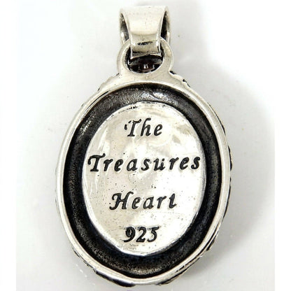 Reverse side of the silver medallion showing 'The Treasures Heart' engraving and a 925 hallmark stamp.