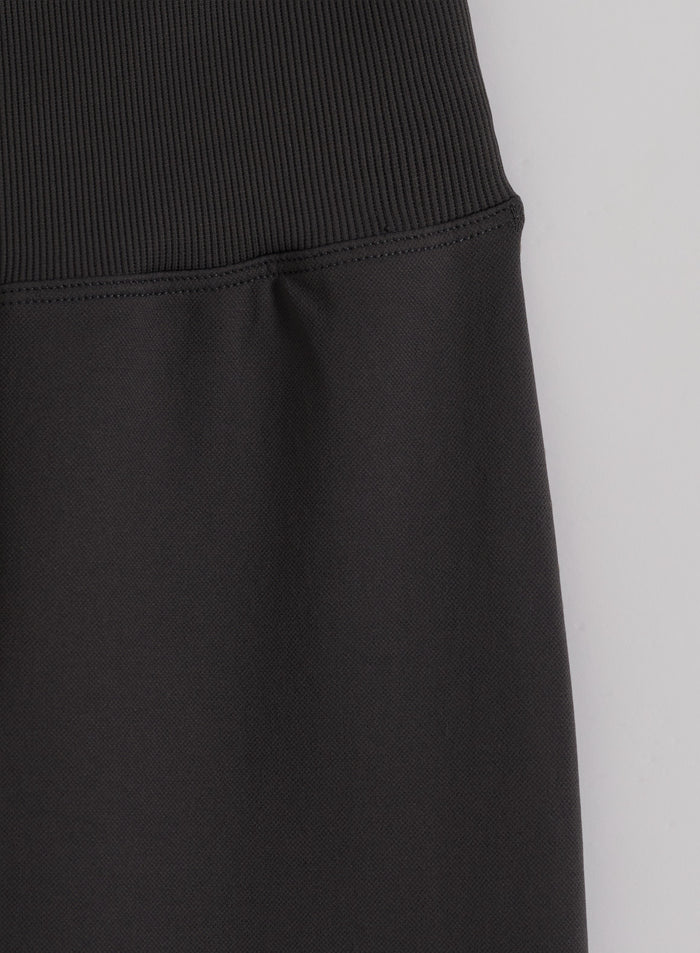 High ribbed waistband on shadow grey seamless flare tights in a close-up flat lay by aim'n.