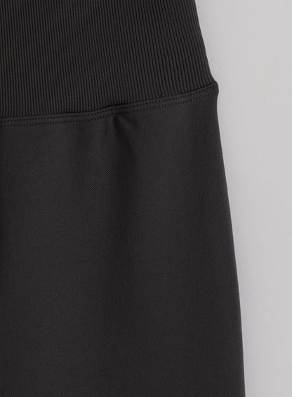 High ribbed waistband on shadow grey seamless flare tights in a close-up flat lay by aim'n.