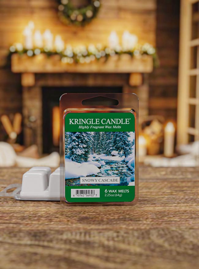 Kringle Candle wax melt package with a snowy landscape design on a wooden surface.