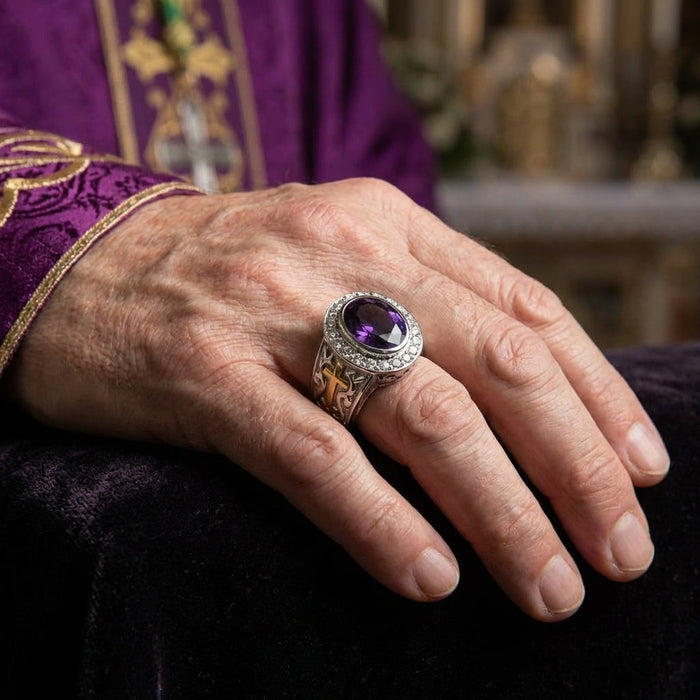 Bishop ring with natural amethyst worn on hand with purple clergy vestment in church setting