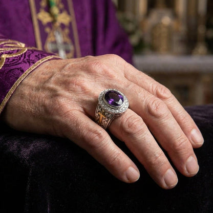 Bishop ring with natural amethyst worn on hand with purple clergy vestment in church setting