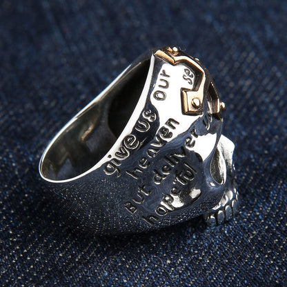 Angled on dark denim, the engraved prayer lettering wraps the band beside a riveted gold cross accent.