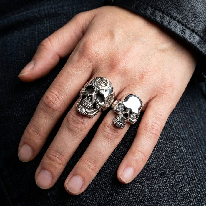 A man's hand wearing the modern skull ring
