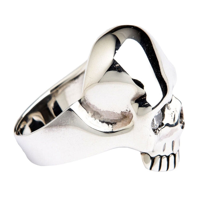 Side profile of the polished skull ring, the eye socket, teeth and jawline reading clearly against plain silver.