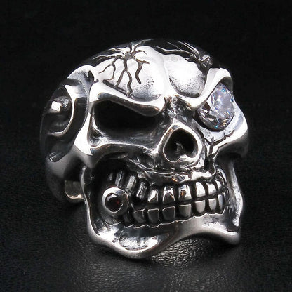 A men's solid sterling silver ring in the shape of a cracked mafia skull with a large clear diamond CZ eye.
