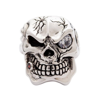 A heavy silver biker ring featuring a mafia skull with a garnet tooth and flame details.
