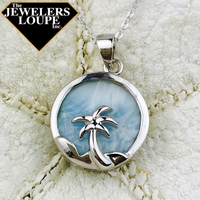 Sterling Silver Palm Tree Pendant with Bezel Set Round Larimar on 18" sterling silver chain.   Larimar, also called "Stefilia's Stone", is a rare blue variety of the silicate mineral pectolite found only in the Dominican Republic, in the Caribbean. Its coloration varies from white, light-blue, green-blue to deep blue.