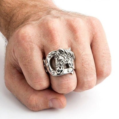 Men's hand wearing the solid silver equestrian ring, showcasing the mid-sized fit of the horse head and horseshoe design.