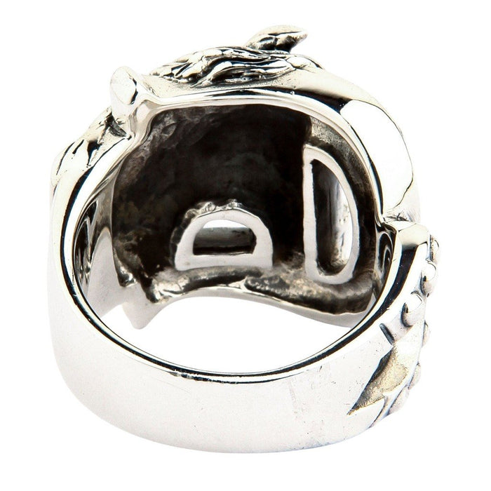Looking up from the bottom band into the dark oxidized recesses and hollowed casting of the sterling silver ring face.