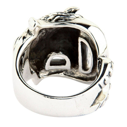 Looking up from the bottom band into the dark oxidized recesses and hollowed casting of the sterling silver ring face.