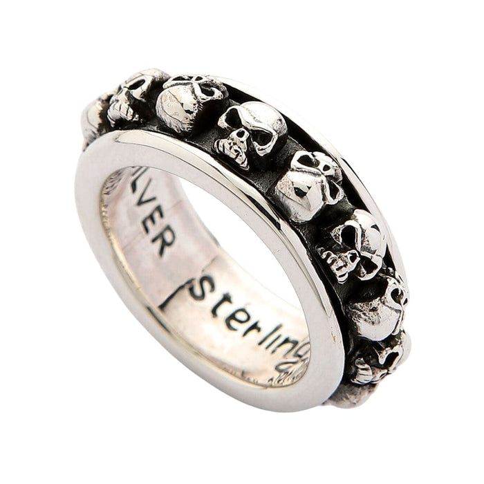 A solid sterling silver skull spinner ring, with a rotating outer band of intricately detailed and oxidized skulls.