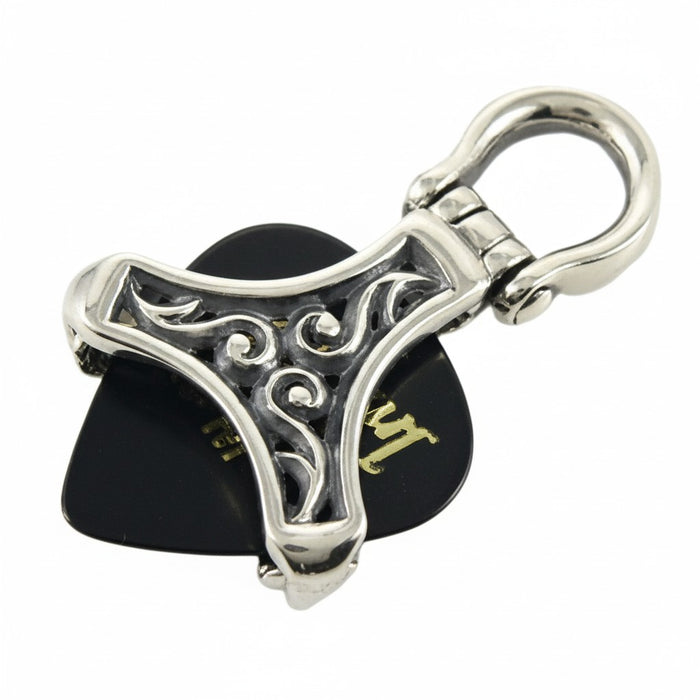 A side view of the silver musician's pendant, showing the cannabis leaf engravings on the bail.