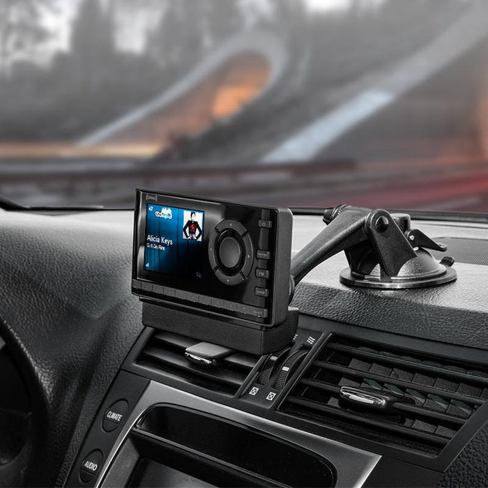 A Sticky Suction Windshield or Dash Car Mount for XM and Sirius Satellite Radio is attached by the car’s air vents, securely displaying Alicia Keys Girl on Fire on the satellite radio receiver.