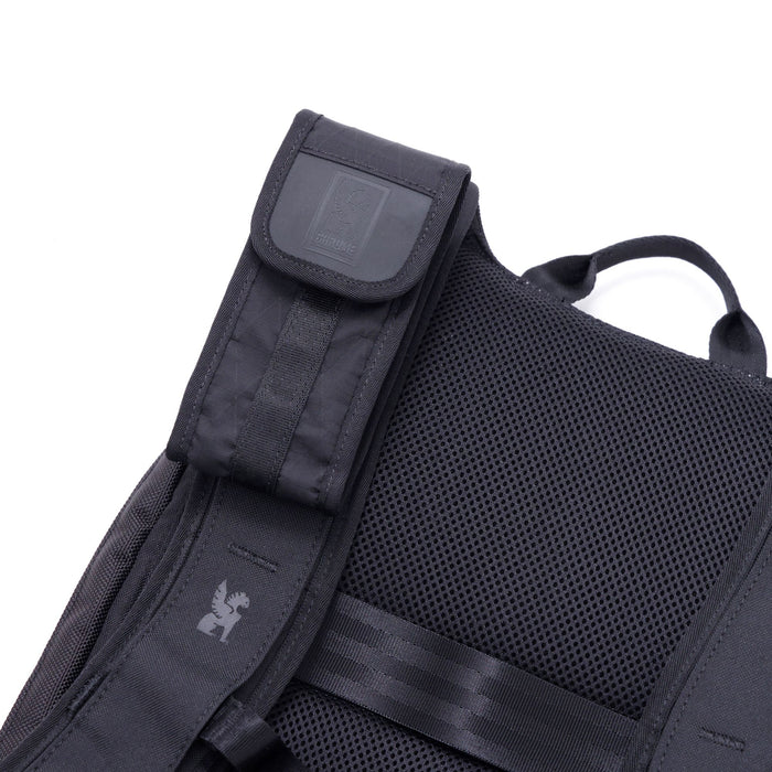 The Sunglass Pouch in black mounted on a backpack strap