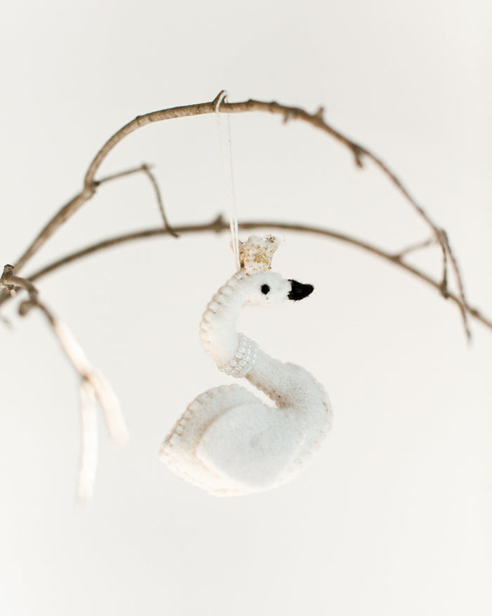 felt white princess swan with pearl necklace and gold crown hanging on a branch