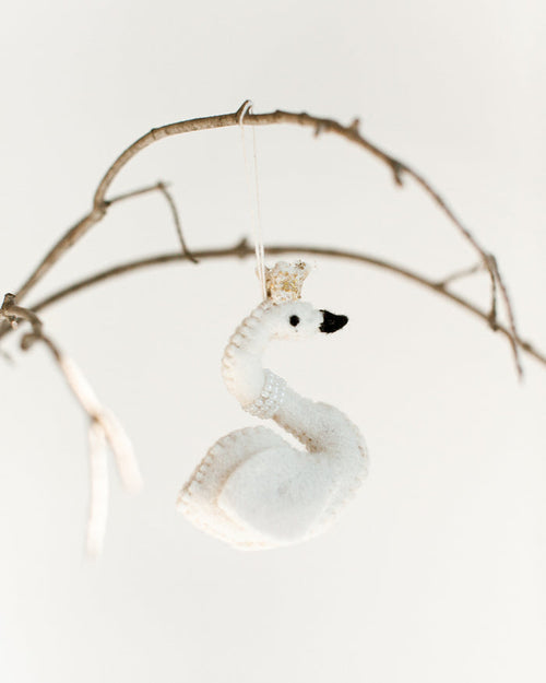 felt white princess swan with pearl necklace and gold crown hanging on a branch