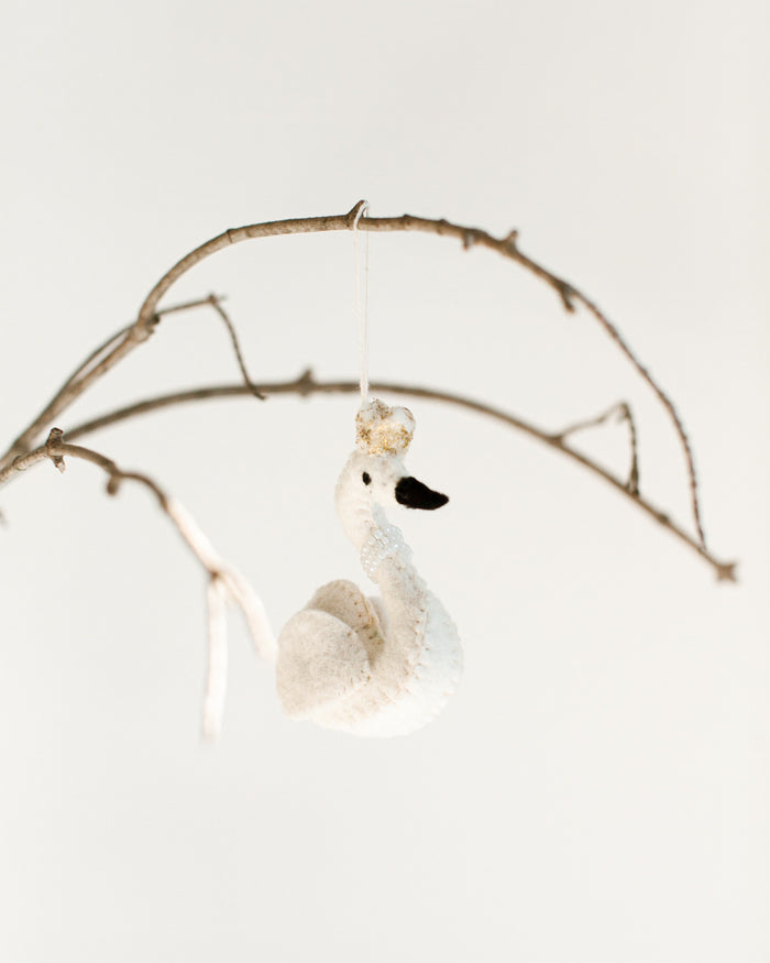 felt white princess swan with pearl necklace and gold crown hanging on a branch