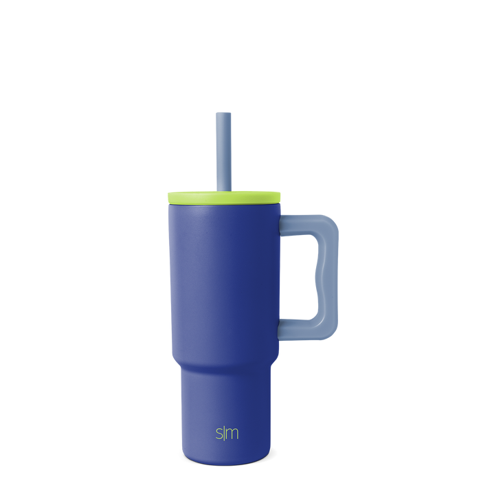 Navy blue tumbler with vibrant lime green lid, rim band, and handle for secure grip and easy carrying.