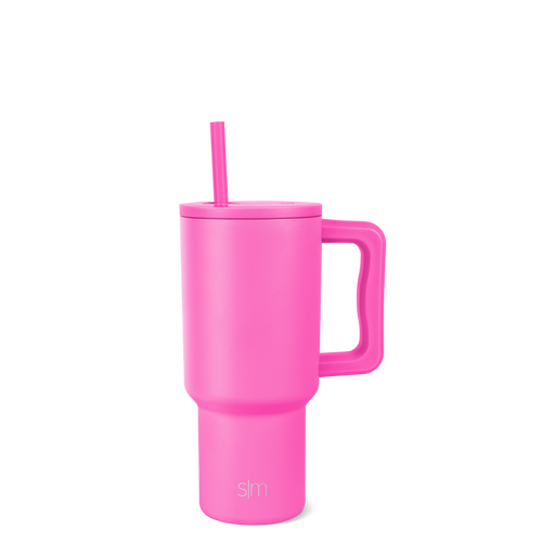Hot pink tumbler with lid and straw on white background