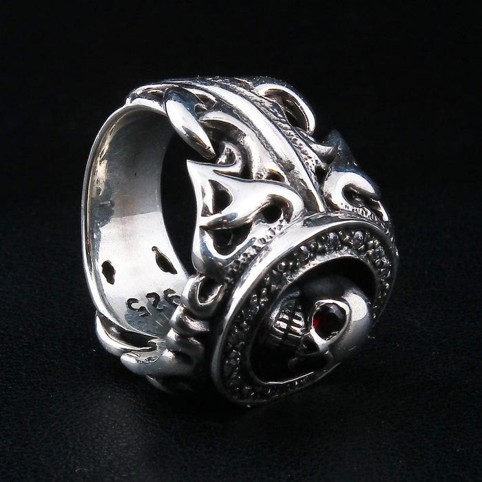 Raised tribal scrollwork wrapping the band beside the skull's profile, the .925 stamp running along the inner edge.