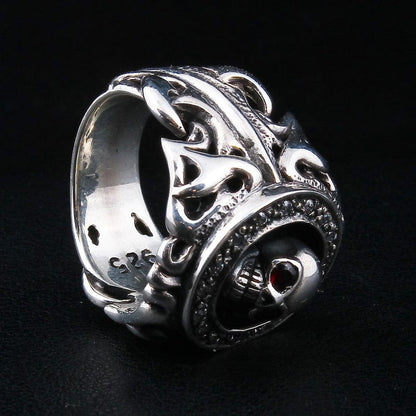 Raised tribal scrollwork wrapping the band beside the skull's profile, the .925 stamp running along the inner edge.