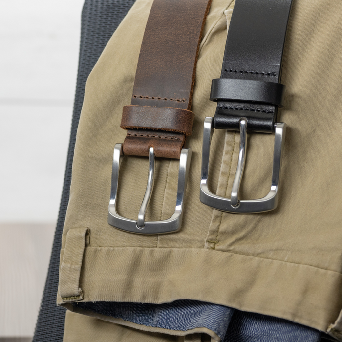 Urbanite Brown and Black belts draped over a pair of khakis