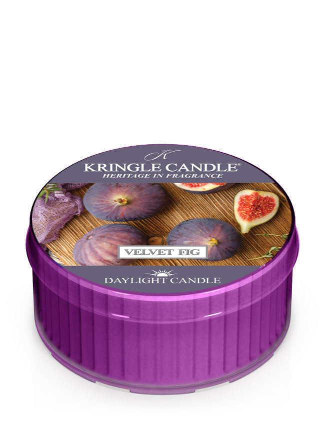 Purple daylight cup, unlit, labeled "Velvet Fig DayLight Candle" with images of figs and fig slices on the lid.