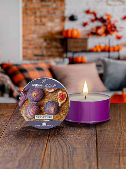 Purple daylight cup, unlit, labeled "Velvet Fig DayLight Candle" with images of figs and fig slices on the lid.