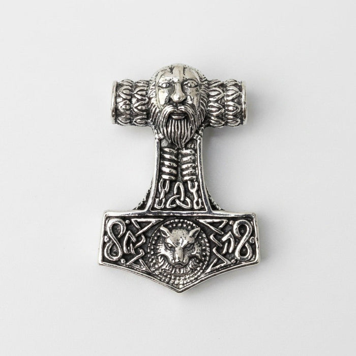 Front view of the sterling silver Mjolnir pendant featuring a bearded face top, knotwork shaft, and Fenrir wolf head base.