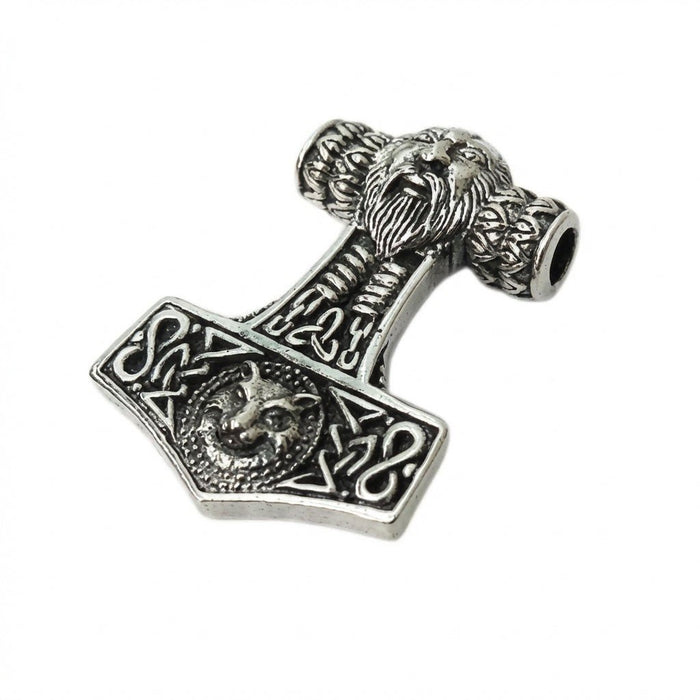 Angled flat lay of the oxidized silver pendant revealing the top chain hole, bearded face bale, and intricate knotwork.