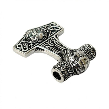 Detailed view of the hollow chain hole passing through the sculpted silver Fenrir wolf head at the top of the hammer.