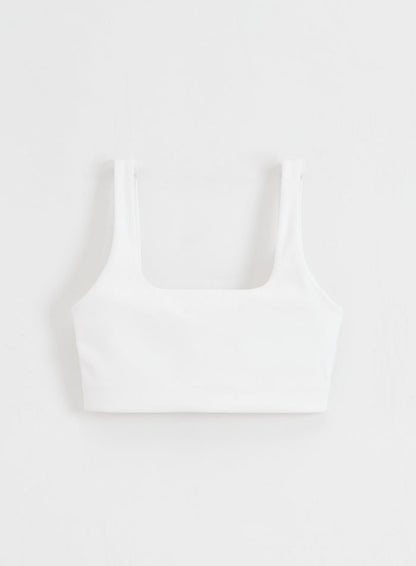White Sense Bra with a square neck and buttery soft fabric by aim'n, shown in a flatlay.