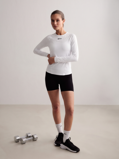 Model wearing a white Soft Basic Long Sleeve with black shorts and dumbbells [S-174 cm]