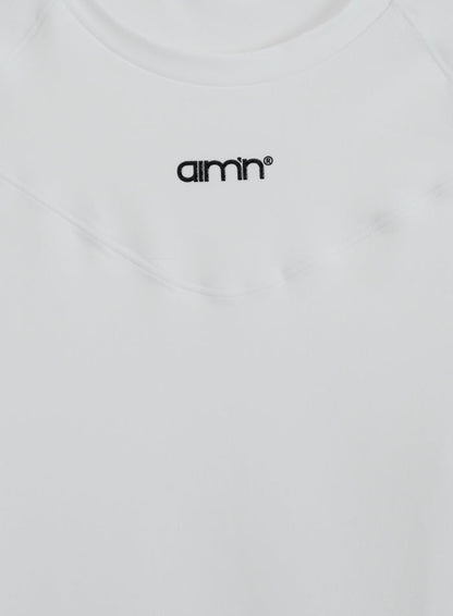 White aim'n Soft Basic Long Sleeve featuring a black printed logo and ultra-soft second skin fabric.
