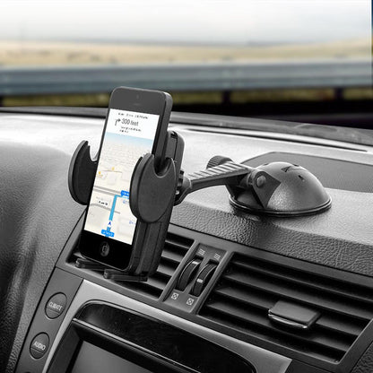A Windshield or Dash Car Mega Grip™ Phone Holder Mount for iPhone, Galaxy, and Note is attached to the dashboard with a suction cup, holding a phone displaying GPS navigation; nearby, car air vents and controls are visible.