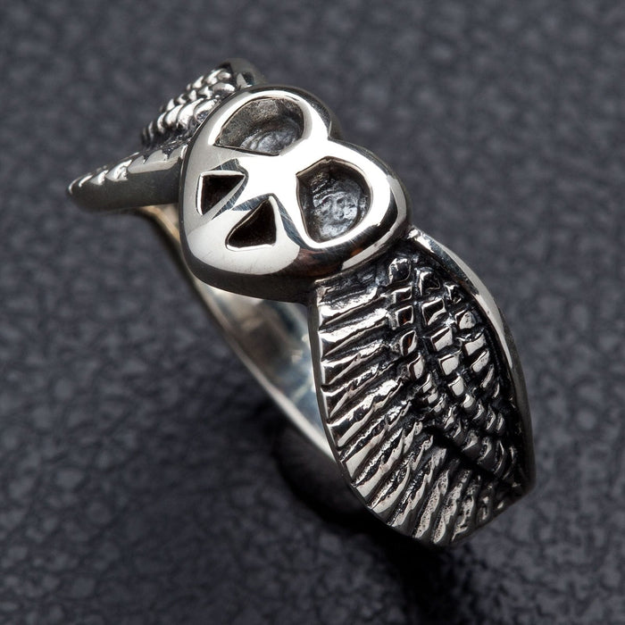 The sterling silver peace wings ring, showing the detailed feather texture and polished finish.