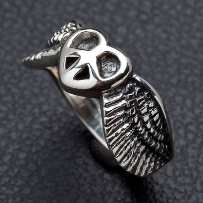 The sterling silver peace wings ring, showing the detailed feather texture and polished finish.