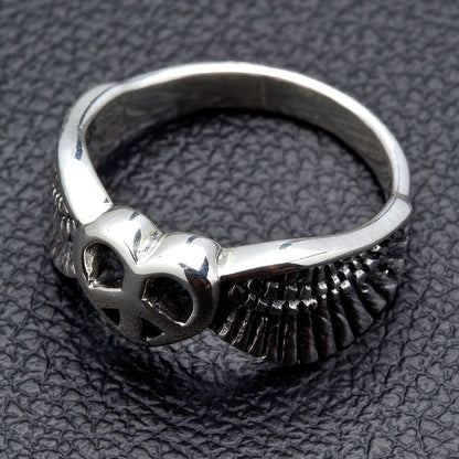 A women's sterling silver ring with a winged heart and peace symbol.