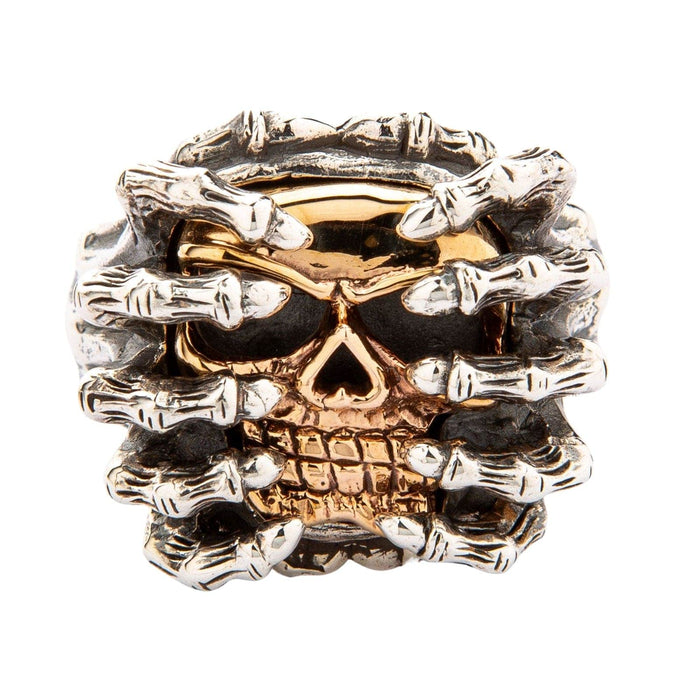 Direct front view highlighting the 14K yellow gold skull face tightly gripped by eight oxidized silver spider legs.