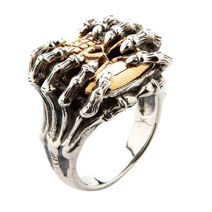 Overhead perspective showcasing the intricate silver spider legs wrapping over the top of the yellow gold skull.