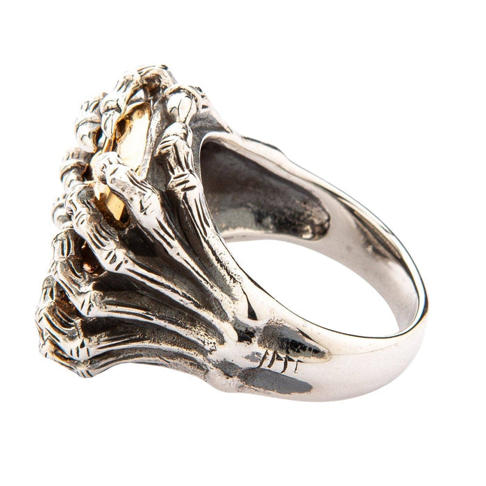 Angled rear perspective showing the textured silver spider legs merging smoothly into the polished lower ring shank.