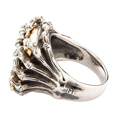 Angled rear perspective showing the textured silver spider legs merging smoothly into the polished lower ring shank.